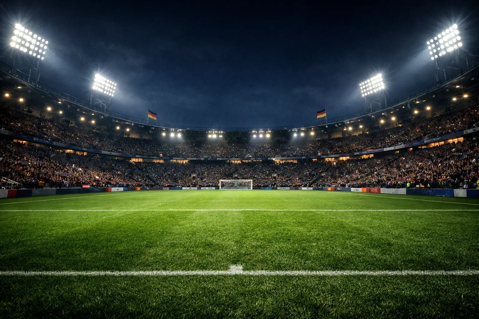 Fußballstadion bei Flutlicht während eines Spiels